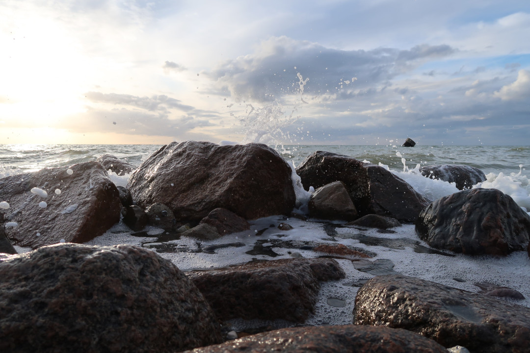 Water breaking on stones of a stony beach